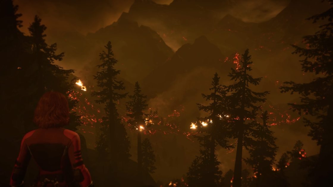 Black Widow stares out into a burning forest countryside.