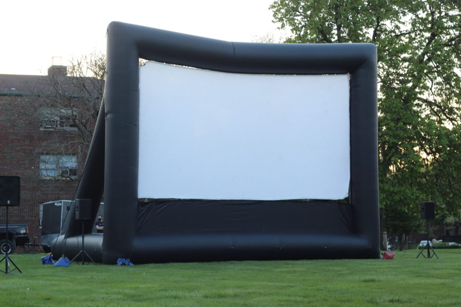 Displayed is a large projector screen that the film was shown on.