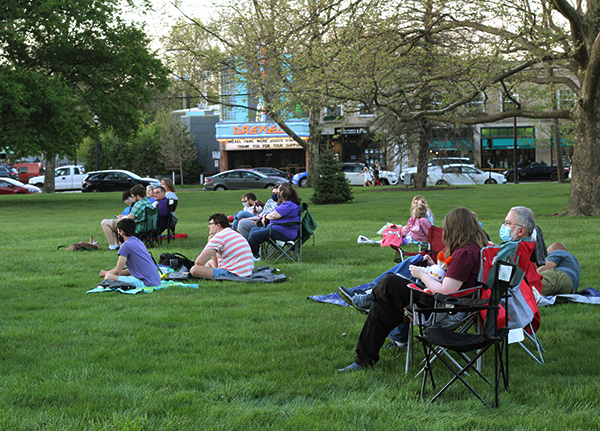 Audience members are shown waiting on Renner Lawn for the premiere of the movie.