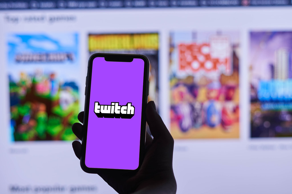 A person holding their phone with the Twitch app open.