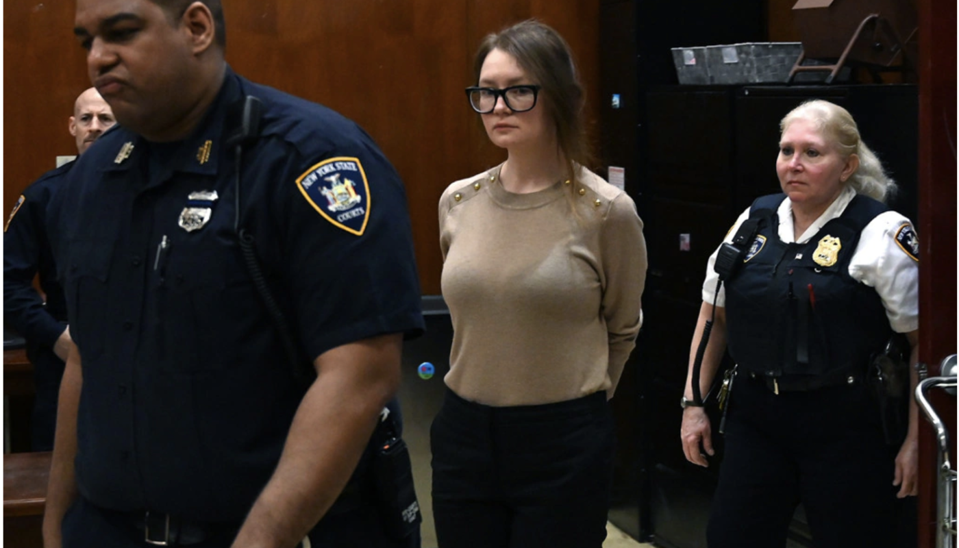 Anna Sorokin seen being led out of a court room in hand cuffs.