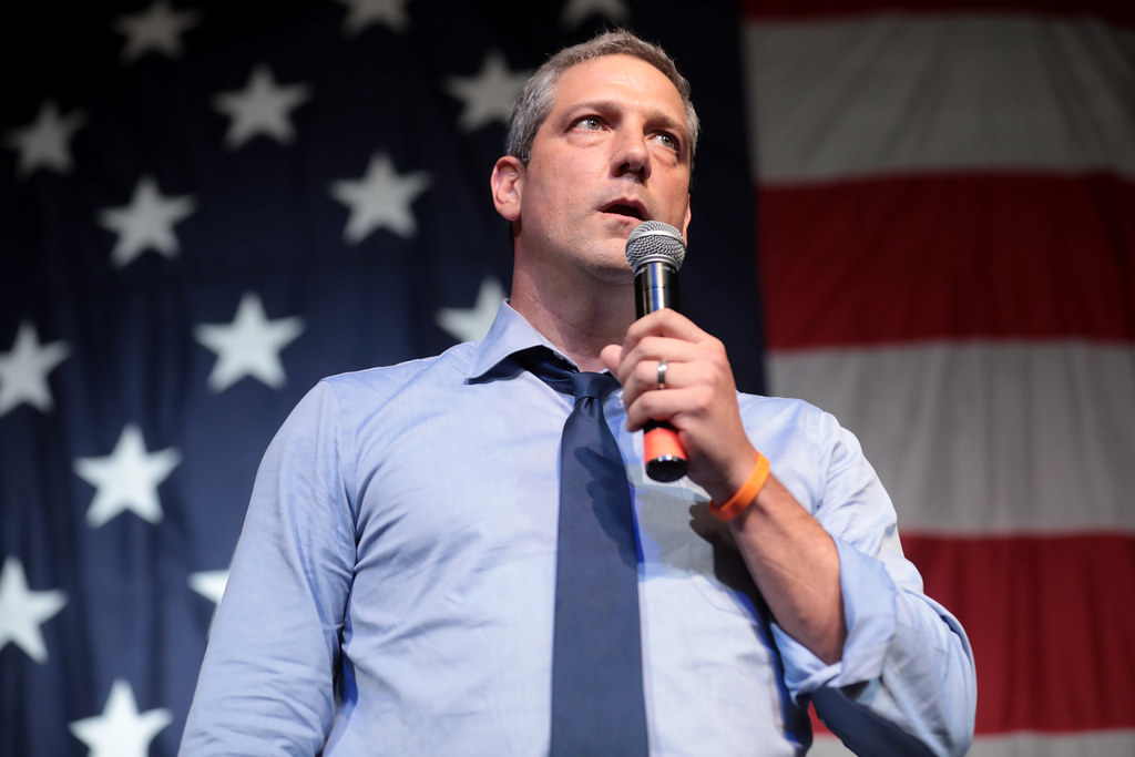 Tim Ryan, U.S. Congressman, is shown giving a speech in front of an American flag.