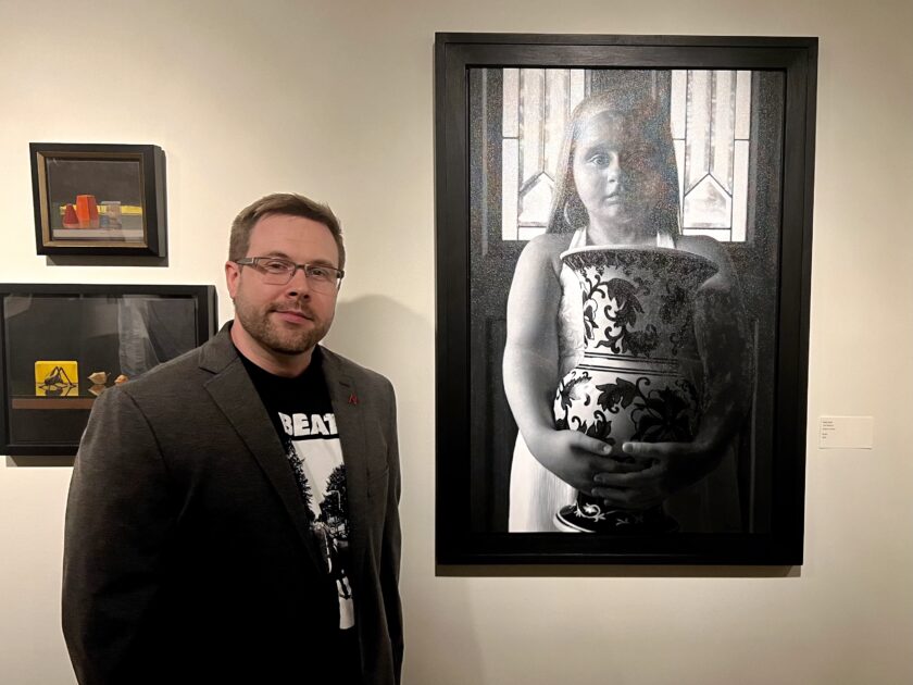 Mark Bush next to his acrylic artwork